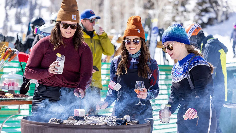 Guests gathering around an open fire at Deer Valley Resort.